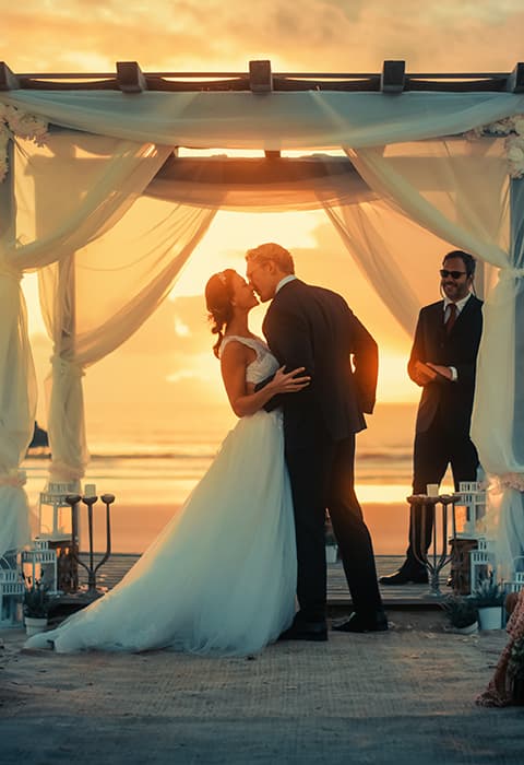 bride and groom embrace on a beach